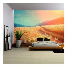 a bedroom with a large mural on the wall and a bed in front of it