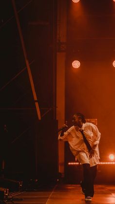 a man in white shirt and tie on stage