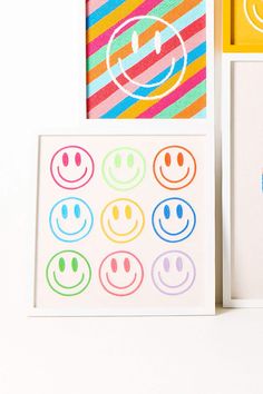 two cards with smiley faces on them next to some other greeting cards and magnets