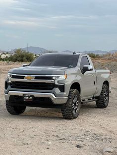 a silver truck is parked in the desert