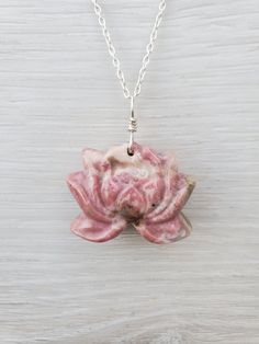 "This pink Rhodonite lotus flower necklace features a carved Rhodonite lotus. Each pink lotus flower is measured approximately 31mm wide and 24mm tall, that is about 1.3\" wide and 1\" tall.  This Rhodonite lotus is drilled, and wire wrapped with solid sterling silver wire. You will receive the exact one as you choose! It is natural pink rhodonite with natural inclusions/other minerals that results in impurities we see in the rhodonite (impurities colors include black, dark green, clear, cream, Holistic Gemstone Round Pendant Jewelry, Holistic Sterling Silver Necklace With Gemstones, Pink Sterling Silver Flower-shaped Jewelry, Adjustable Flower Shaped Gemstone Jewelry, Pink Gemstone Flower-shaped Jewelry, Flower Shaped Natural Stones Jewelry Gift, Spiritual Jewelry With Flower Charm Round Pendant, Flower Shaped Natural Stones Jewelry For Gift, Spiritual Jewelry With Flower Charm Pendant