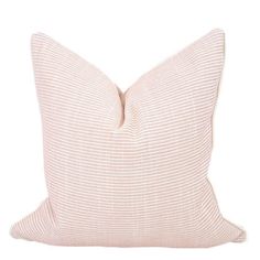 a pink and white pillow on a white background