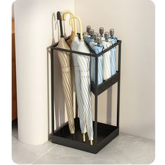 two umbrellas are hanging on the wall next to each other in a holder with four different color umbrellas