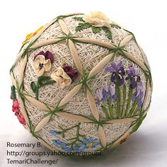 an ornament made out of yarn with flowers on it