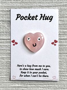 a card with a pink heart on it that says pocket hug here's a hug from me to you, so show how much i care keep it in your pocket, for when i can't be there