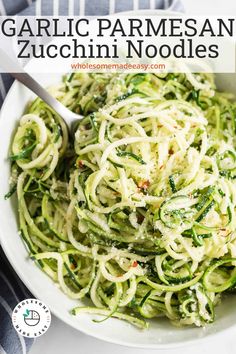 a white bowl filled with zucchini noodles on top of a table