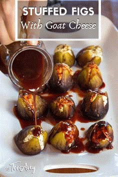 stuffed figs with goat cheese and caramel sauce are on a white platter