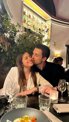 a man and woman sitting at a restaurant table