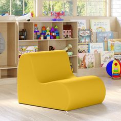 a child's room with toys and bookshelves on the floor, including a blue chair