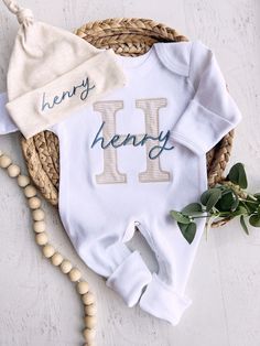 a baby's first birthday outfit with the letter h on it and a hat