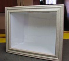 a white frame sitting on top of a table