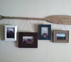 several different frames hanging on a wall with a surfboard