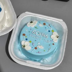 a blue cake in a plastic container with the words going twenty two on it