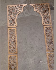 an intricately carved wooden arch on the ground