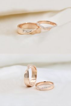 two gold wedding rings with diamonds on top and bottom, sitting on a white sheet