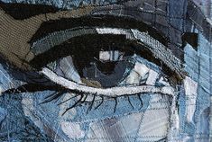 an eye is seen through the fabric on a piece of clothing that has been stitched together