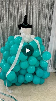 a dress made out of balloons sitting on top of a table