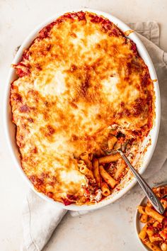 a casserole dish with pasta and cheese in it on a white table top