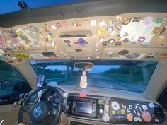 the interior of a car with many stickers on the dash board and steering wheel