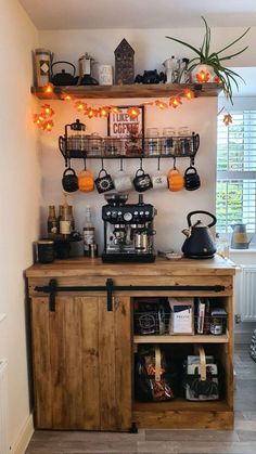 the coffee bar is decorated with hanging lights and potted plants on shelves above it