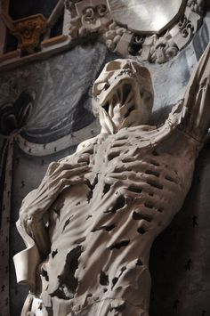 the skeleton of a man is displayed in front of a clock