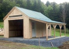 a small wooden garage sitting in the middle of a field next to a wooded area