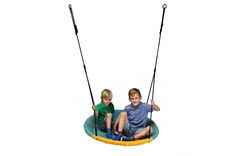 two young boys sitting on a swing