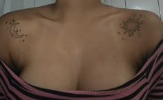 a woman with sun and moon tattoos on her chest