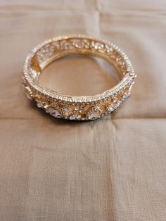 The bangle has 5 carats of round and oval clear zircon with a swirled open design on the band.  Side opening.  Size medium.  14K gold plated. Jeweled Gold Plated Bracelet For Wedding, Victorian Bracelet, Genoa, Open Design, Bangle Bracelet, Body Jewelry, Jewelry Inspiration, Diamond Bracelet, The Band