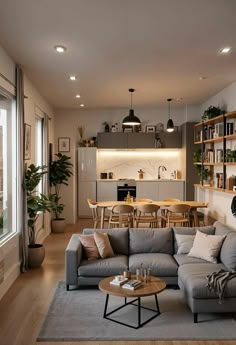 a living room filled with furniture next to a window covered in plants and potted plants