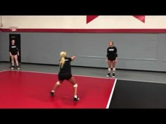 some girls are playing volleyball in a gym