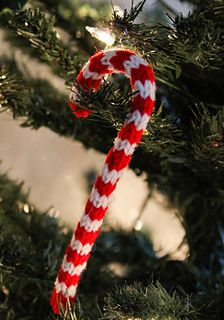 a candy cane is hanging on the christmas tree