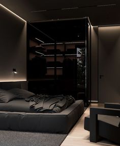 a bed sitting in the middle of a bedroom next to a black wall and floor