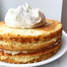 a stack of pancakes with whipped cream on top