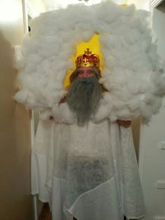 a man with a beard wearing a crown and clouds on his head is standing in front of a mirror