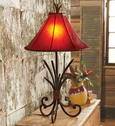 a red lamp sitting on top of a wooden table