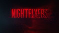 a red sign that says nightflyer on it in front of a dark background