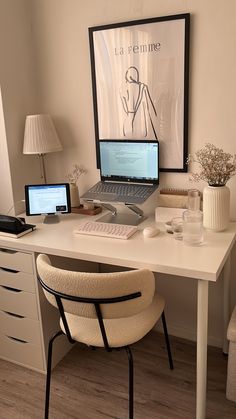 a laptop computer sitting on top of a white desk next to a lamp and chair