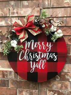 a merry christmas yall sign hanging on a brick wall