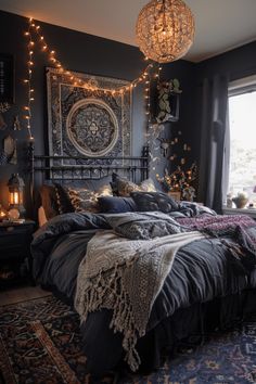 a large bed sitting in a bedroom next to a window with string lights hanging from the ceiling