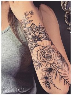 a woman with a flower tattoo on her arm