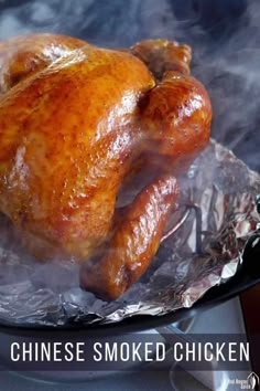 a cooked chicken is sitting on top of tin foil with the words chinese smoked chicken