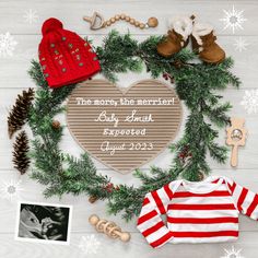 a christmas wreath with baby's shoes, sweaters and other items on it