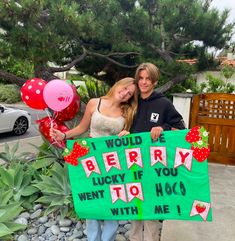 two women holding a sign that says i would be berry lucky if you went to hoo with me