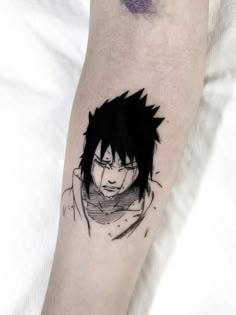 a person with a black and white tattoo on their arm that has an anime character drawn on it