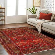 a living room with a couch and rug on the floor