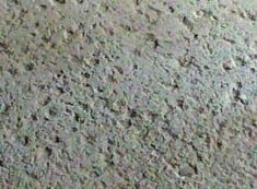 a close up view of the surface of a concrete floor with small holes in it