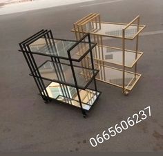 three glass shelves sitting on top of each other in the middle of an empty parking lot