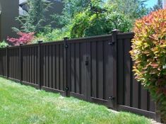 a brown fence in front of a house