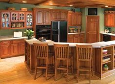 a large kitchen with wooden cabinets and an island